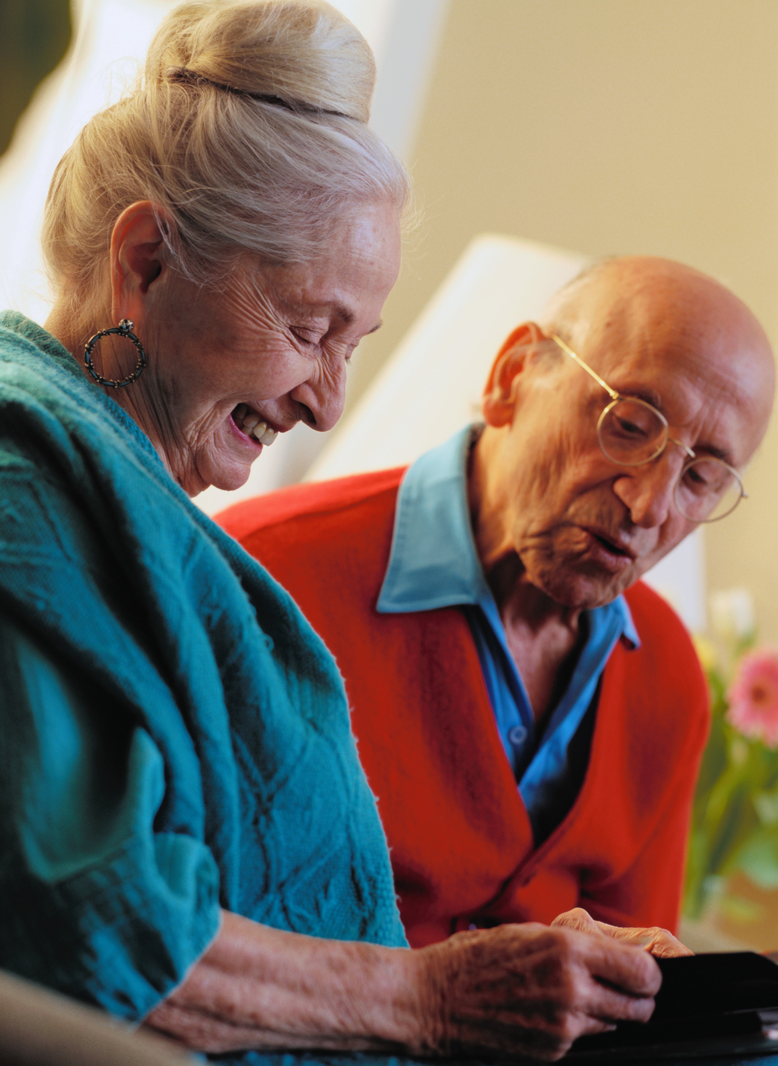 Colleage of man and woman, a man holdin ga veteran's hat and a woman and main in wheelchairs convesing
